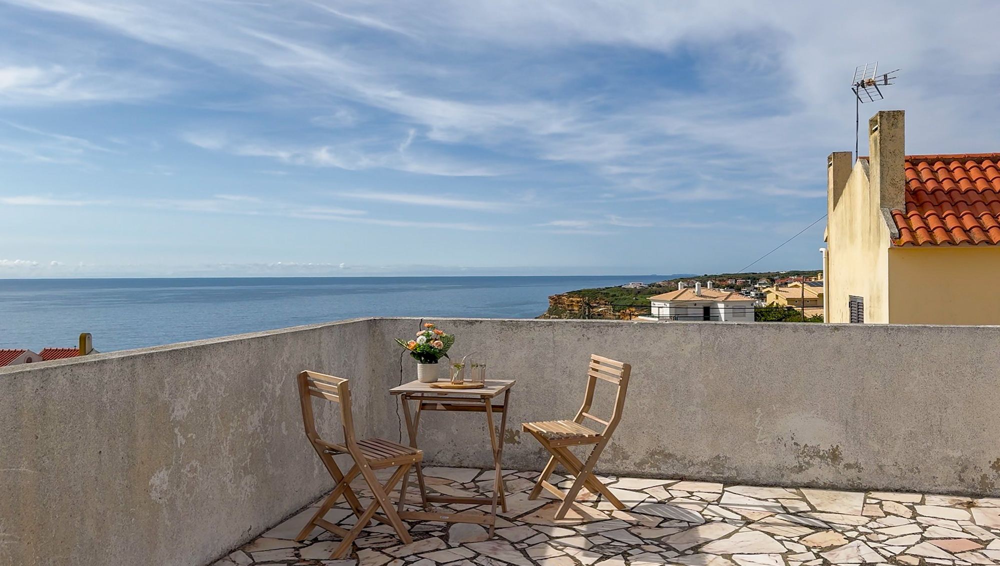 Terraço com mesa e vista mar